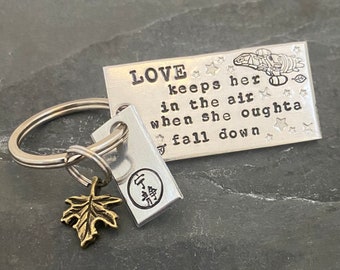 Hand stamped "LOVE keeps her in the air..." Firefly inspired keychain with hand stamped charm