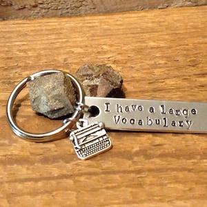 Hand stamped keychain, "I have a large vocabulary" with typewriter charm