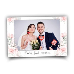 Könnte beinhalten: Ein Hochzeitsfotorahmen mit floralem Rand, der ein Paar mit Requisiten mit den Worten "XOXO" und "LOVE" zeigt. Der Rahmen enthält die Namen "Paul & Sarah" und das Datum "août 31 2026".
