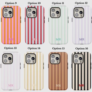 May include: A collection of eight phone cases with vertical stripe designs in various colors. The cases feature stripes in orange, pink, red, blue, green, purple, white, beige, and brown. Each case has the initials "MR" printed at the bottom.
