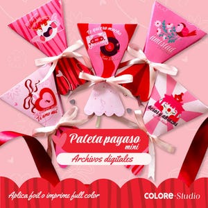 May include: A collection of pink and red Valentine's Day-themed paper lollipop holders tied with white ribbons. Each holder features a unique design with text and illustrations, including hearts, birds, and the words "Te amo asi".