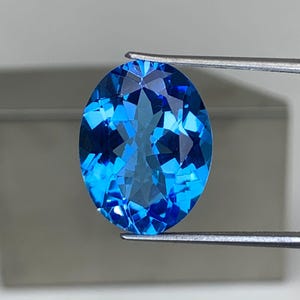 Swiss Blue Topaz Gemstone: 11.97 Carat Oval Faceted Stone
