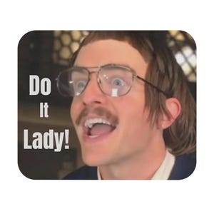 May include: A square coaster featuring a man with glasses and a mustache, with the text "Do It Lady!" in white block letters. The man has a surprised expression with his mouth open.