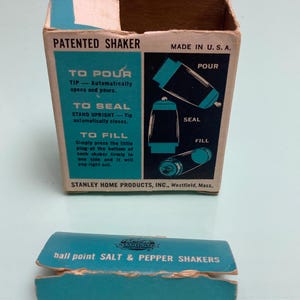 May include: Vintage salt and pepper shaker set in its original box. The box is rectangular with a teal and brown color scheme, featuring instructions and the text "PATENTED SHAKER" and "MADE IN U.S.A.". The box also includes a separate teal-colored lid.