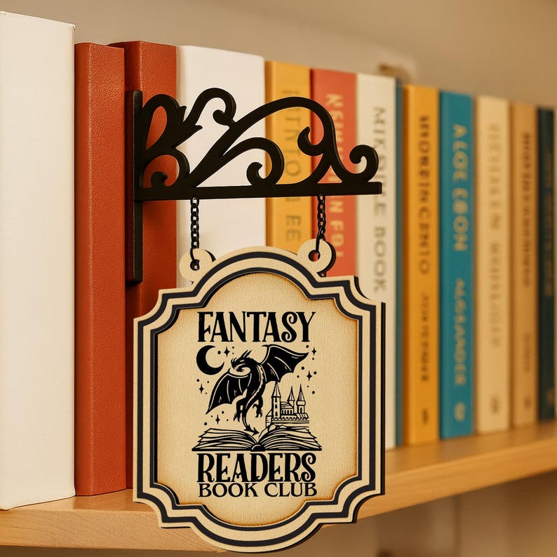 May include: A wooden sign for a fantasy book club, featuring a dragon, castle, and open book design. The sign hangs from a black metal bracket with a decorative scroll design. The text on the sign reads "FANTASY READERS BOOK CLUB."