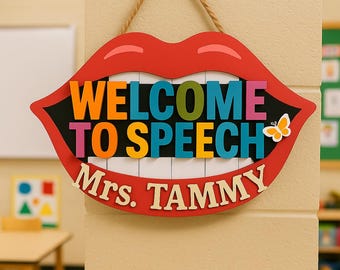 May include: A wooden sign in the shape of red lips with the words "WELCOME TO SPEECH Mrs. TAMMY" in colorful letters. A small butterfly is on the right side of the sign. The sign is hanging from a tan rope.