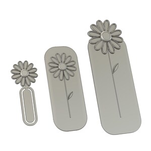 May include: Three light grey bookmarks of varying sizes, each featuring a raised daisy flower design at the top. The smallest bookmark has a paperclip-style base, while the two larger bookmarks are rectangular with rounded edges and a stem.
