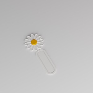 May include: A white bookmark featuring a daisy flower design at the top with a yellow centre and white petals. The lower portion of the bookmark consists of a simple, elongated oval loop shape, providing a clean and functional design for marking pages.