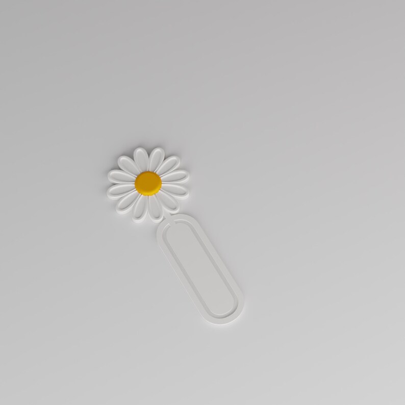 May include: A white bookmark featuring a daisy flower design at the top with a yellow centre and white petals. The lower portion of the bookmark consists of a simple, elongated oval loop shape, providing a clean and functional design for marking pages.