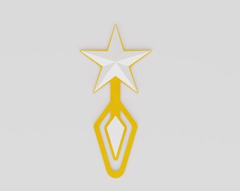 May include: A gold-colored bookmark with a white star at the top and a geometric design. The star has a white center and gold outline. The bookmark's design includes a white diamond shape.