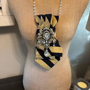 Upcycle necktie transformed into one of a kind necklace with broach