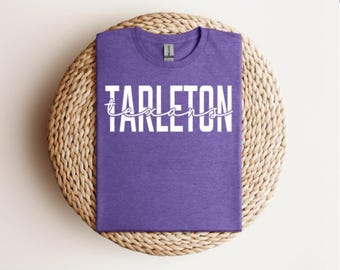 May include: Purple t-shirt with white text that reads "Tarleton Texans".