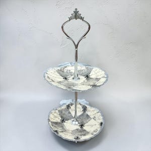 Smyckesställ i två våningar, silver med snäckskal och Fleur-de-lis-tema.