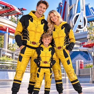 May include: Matching yellow and black hooded sweatshirts and sweatpants featuring a printed armour design with a red X-Men logo on the waist. The garments have long sleeves, ribbed cuffs, and knee padding details, creating a cohesive superhero-inspired look.