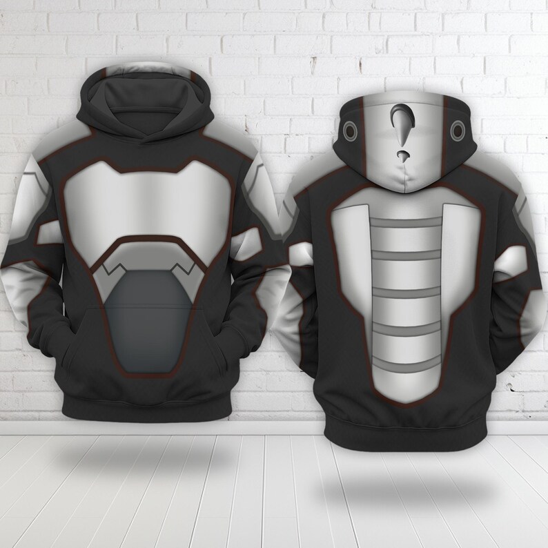 May include: A black hoodie featuring a printed graphic design of silver metallic armor plating on the front and back. The hood displays a white face mask pattern with a black question mark symbol on the forehead and circular accents on the sides.