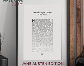 May include: A framed print of the first page of "Northanger Abbey" by Jane Austen. The text is in black on a white background, with the title at the top and "Jane Austen Edition" at the bottom. The frame is black.