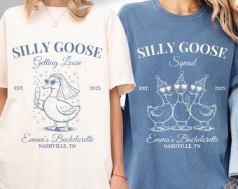 May include: Two t-shirts, one ivory and one blue, featuring the text "SILLY GOOSE" and a duck graphic. The ivory shirt says "Getting Loose" and the blue shirt says "Squad". Both shirts include "Emma's Bachelorette" and "Nashville, TN".