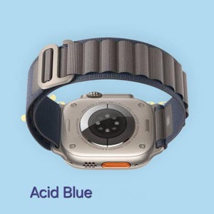 May include: A silver smartwatch with a blue and gray band. The watch has an orange button and the text "Acid Blue" is at the bottom of the image. The band is made of a textured material.