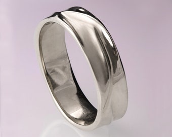 May include: A silver wedding band with a unique, curved design. The band is smooth and polished, with a slightly rounded edge.