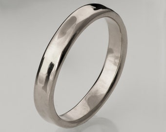 May include: A simple silver wedding band with a hammered finish.