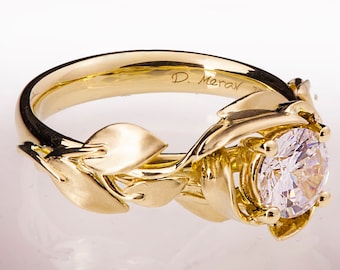 May include: A gold ring with a large round diamond set in a floral design. The band is inscribed with "D. Merav".