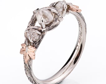 May include: A silver ring with a twisted band and three rough-cut diamonds. The band is decorated with a leaf design in rose gold. The ring is engraved with "D. Harvey 1805".