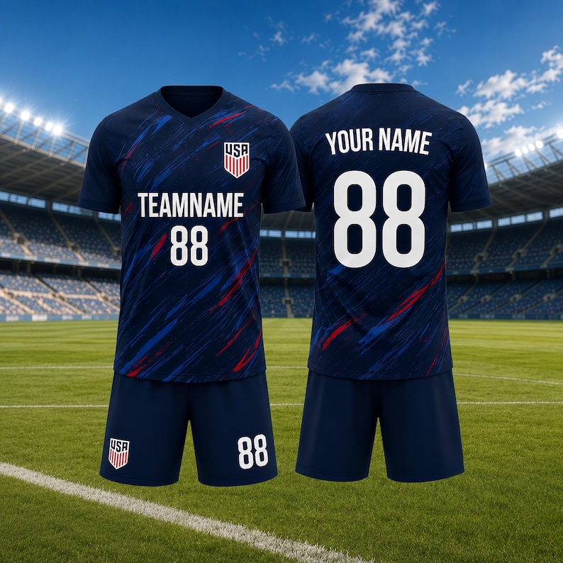 May include: Navy blue soccer uniform set with red and blue accents. The jersey features "TEAMNAME" and the number "88" in white, along with a USA crest. The shorts also display the number "88". The back of the jersey has "YOUR NAME" and the number "88".