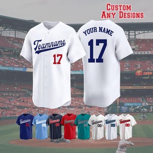 May include: White baseball jersey with "Teamname" in navy blue script and the number 17 in red. The back of the jersey shows "Your Name" and the number 17 in navy blue. The image also shows various colour options and the text "CUSTOM ANY DESIGNS".