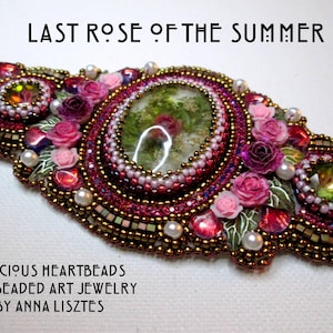 May include: A beaded jewelry piece with a large oval-shaped cabochon in the center. The cabochon is filled with dried flowers and greenery. The piece is surrounded by pink and white flowers and beads. The text "LAST ROSE OF THE SUMMER" is at the top of the image. The text "PRECIOUS HEARTBEADS FINE BEADED ART JEWELRY BY ANNA LISZTES" is at the bottom of the image.