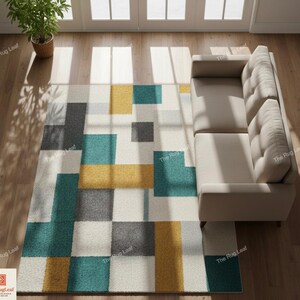 May include: Geometric patterned area rug with teal, yellow, gray, and white squares. The rug is rectangular and placed on a hardwood floor, next to a beige sofa. A potted plant is in the upper left corner.