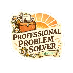 May include: A sticker featuring the text "PROFESSIONAL PROBLEM SOLVER" in brown. The design includes a toolbox with tools, a rising sun, and floral accents. The DSPLife logo is at the bottom.