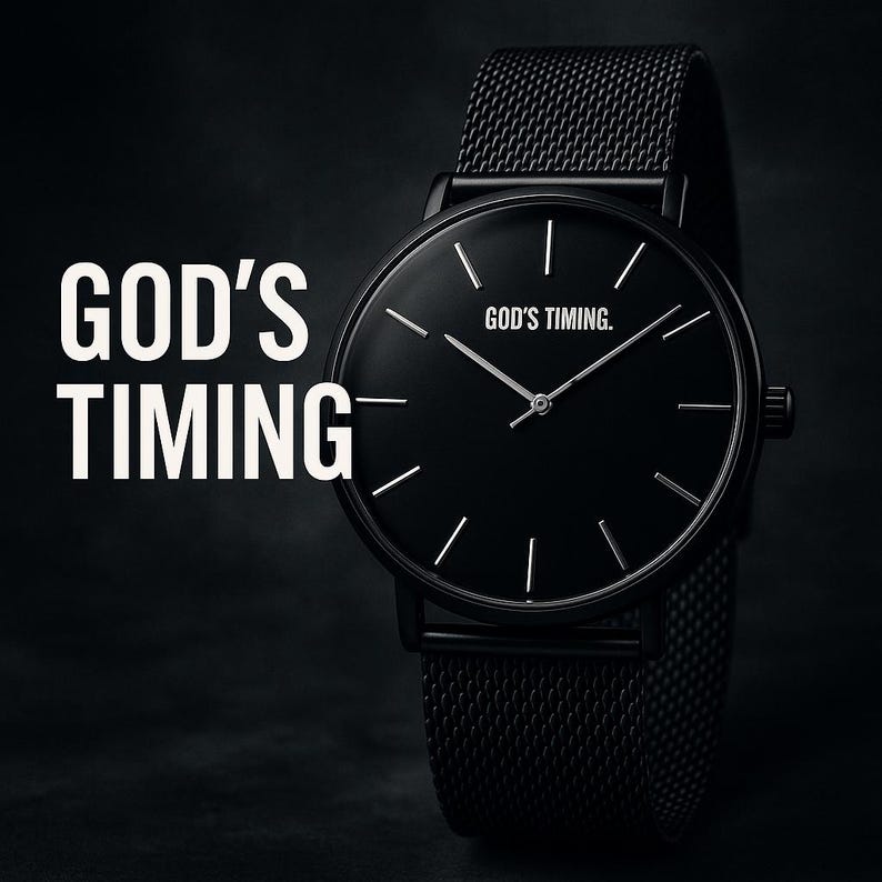 May include: A black wristwatch with a mesh band. The watch face is black with silver hands and markers. The text "GOD'S TIMING" is on the left, and "GOD'S TIMING." is on the watch face.