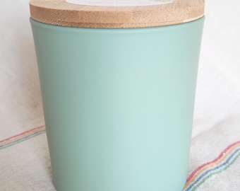 Fountain of Youth scented soy candle in 11 oz teal glass jar with wooden lid