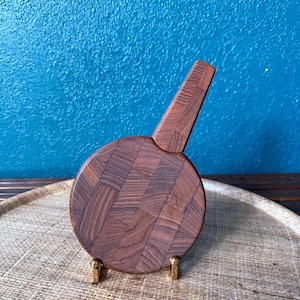 May include: A white ceramic mug with a black handle and the text "But First, Coffee" in a handwritten style. The mug is on a white surface. The mug is 4 inches tall.