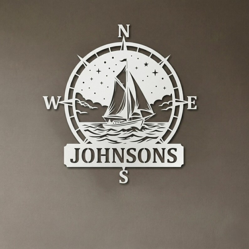 Personalized nautical compass metal wall decor featuring a sailboat at sea with custom family name, designed in a round coastal style. Available in multiple sizes and finishes including black, gold, silver, bronze, and white. Ideal for living rooms, entryways, beach houses, lake houses, or outdoor walls. Easy to hang and weather resistant. A unique gift for sailors, ocean lovers, housewarming, weddings, or modern coastal home decor.