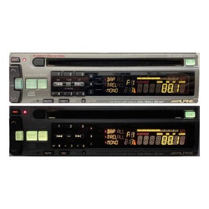 May include: Two car stereo head units, one silver and one black, with digital displays and button controls. The silver unit has a CD player slot. Both units display radio frequency information and the Alpine brand name.