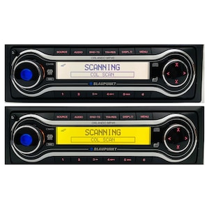 May include: Two black car stereo units with the text "SCANNING" on the display. The units have buttons labelled "SOURCE", "AUDIO", and "MENU". The brand name "BLAUPUNKT" is visible.