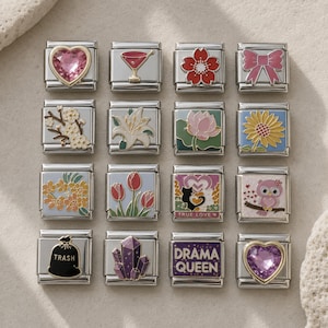 May include: A collection of sixteen square stainless steel modular bracelet links featuring various enamel designs including a pink heart gem, martini glass, flowers, a bow, a cat, an owl, a trash bag, purple crystals, and the text DRAMA QUEEN.