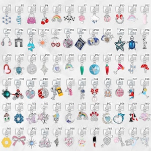 May include: A collection of silver-tone charm pendants with various designs, including a purse, cherries, a rainbow, a heart, a turtle, a star, a bow, a flower, and a lucky charm. Each charm is attached to a silver-tone keychain.