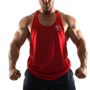 May include: A red tank top with the text "Heavyweight Iron Law" in white. The sleeveless top has a scoop neck and is made of a soft material. This athletic apparel is designed for workouts and gym sessions.