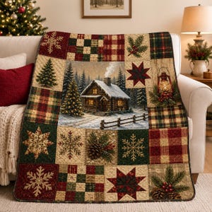 May include: A quilted throw blanket featuring a central scene of a snow-covered log cabin with a chimney, surrounded by patchwork squares displaying snowflakes, pine branches with pinecones, red and green plaid patterns, and a lit lantern.