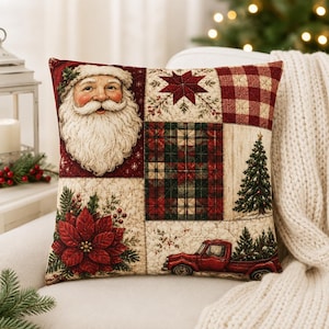 May include: A square decorative cushion featuring a patchwork design with a Santa Claus face, a red and white star, red and white buffalo plaid, a red and green plaid pattern, a poinsettia flower, a pine tree, and a red pickup truck.