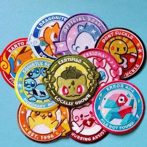 May include: A collection of colorful embroidered patches with various designs and text. The patches feature cartoon characters and phrases like "Dragonite," "Squirtle Squad," and "Error 404." The patches are round and have a stitched border.