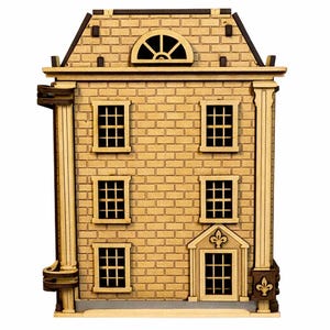 May include: A wooden miniature house with a brick facade, featuring six windows with grid patterns and a half-circle window at the top. The house has a detailed roof and decorative columns, and a fleur-de-lis above the front door.