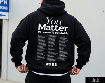May include: Black hoodie with the text "You Matter" and "99 Reasons To Stay Awhile" in white. The back of the hoodie features a list of 99 reasons. The number "#988" is printed below the list. The word "black" is printed on the bottom right.