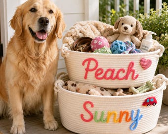 May include: A golden retriever sits beside two stacked white rope baskets. The top basket features the word Peach in pink yarn and a red heart. The bottom basket features the word Sunny in multicolored yarn and a small red car applique.