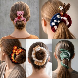 May include: A collection of five crochet hair scrunchies featuring various designs: a pink teddy bear holding a red rose, an American flag pattern with a bald eagle, a black butterfly with yellow and red wings, a sleeping orange tabby cat, and a green snake.