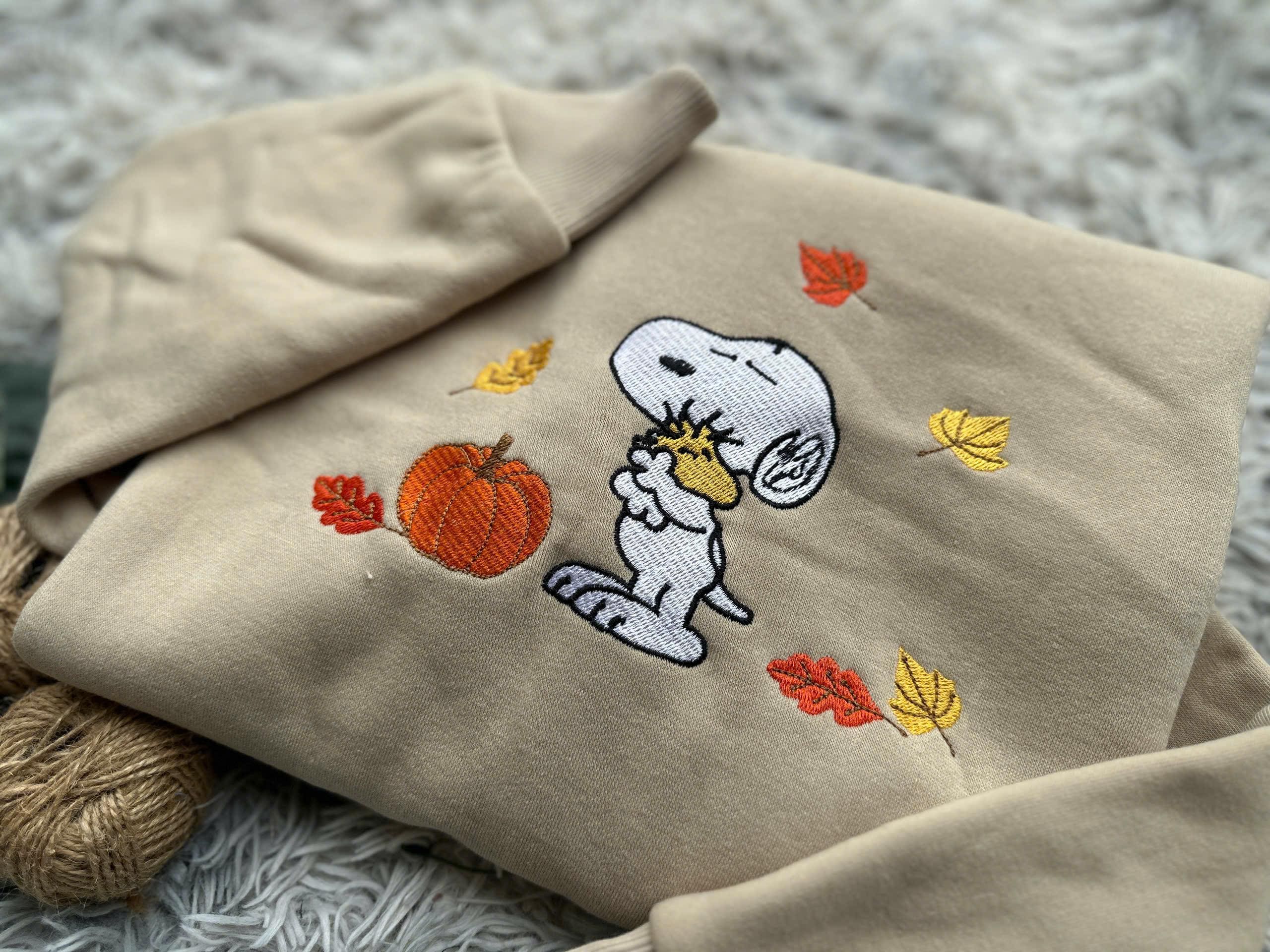 Snoopy Fall Embroidered Sweater – Autumn Leaves & Pumpkin Design | Cozy Unisex T-Shirt, Hoodie, Sweater | Cute Gift for Peanuts Fans