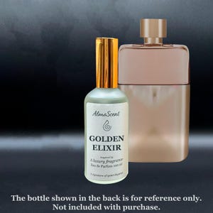 May include: A perfume bottle with a gold cap and a label that reads "GOLDEN ELIXIR" with the brand name "AlmaScent". The bottle is next to a larger, rectangular perfume bottle. The text on the label says "Eau de Parfum 100 ml".