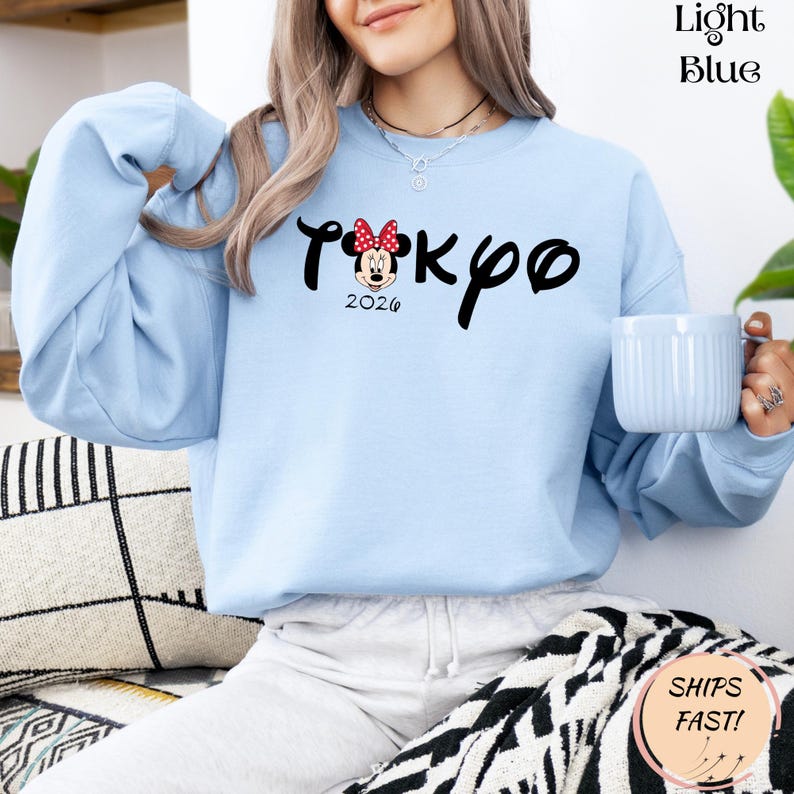 May include: A white ceramic mug with a black handle and the text "But First, Coffee" in a bold, black font. The mug is set against a neutral background, highlighting its simple design.